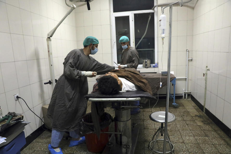 A man is treated at a hospital after a deadly attack at Kabul University, in Kabul, Afghanistan, Monday, Nov. 2, 2020. The brazen attack by gunmen who stormed the university has left many dead and wounded in the Afghan capital. The assault sparked a hours-long gunbattle. (AP Photo/Rahmat Gul)