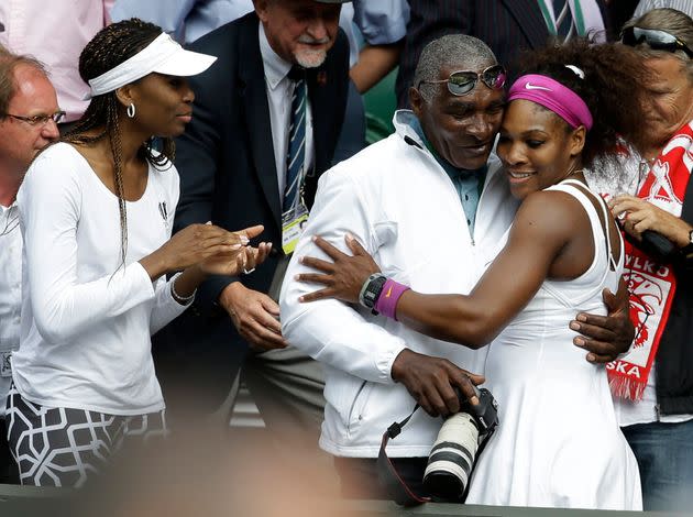 Venus Williams (left) and Serena Williams (right) with their father (center) at Wimbledon in 2012.  (Photo: via Associated Press)