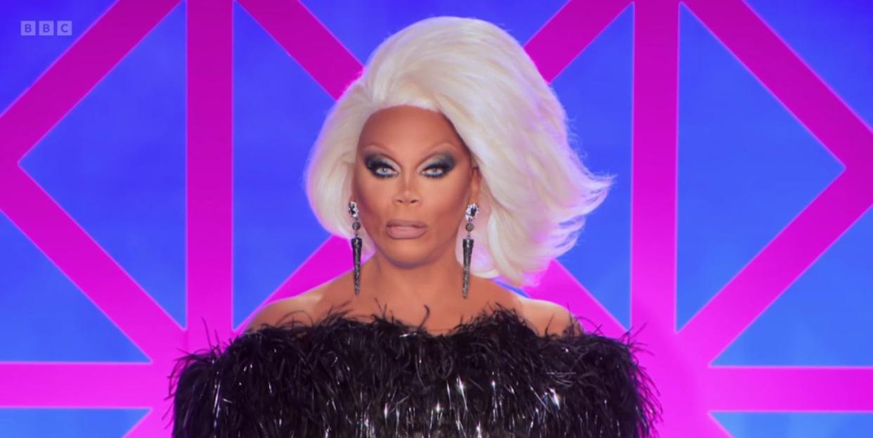 rupaul in drag race uk s5 episode 5, with a short white wig and a black outfit