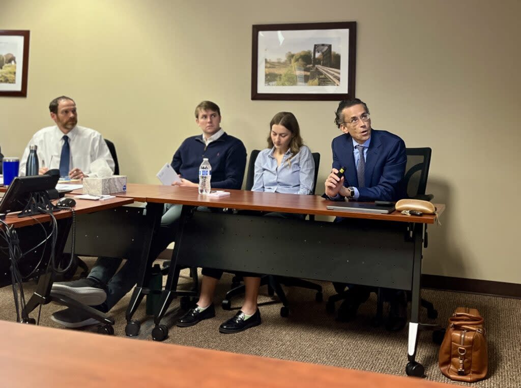 Joseph Santos, at right, director and professor of economics at the Ness School of Management and Economics at South Dakota State University, gives a presentation to the South Dakota Banking Commission and staff in Sioux Falls on May 9, 2024. (Joshua Haiar/South Dakota Searchlight)