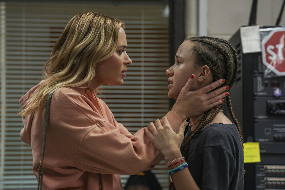 This image released by Netflix shows Emily Blunt, left, and Chloe Coleman in a scene from "Pain Hustlers." (Brian Douglas/Netflix via AP)