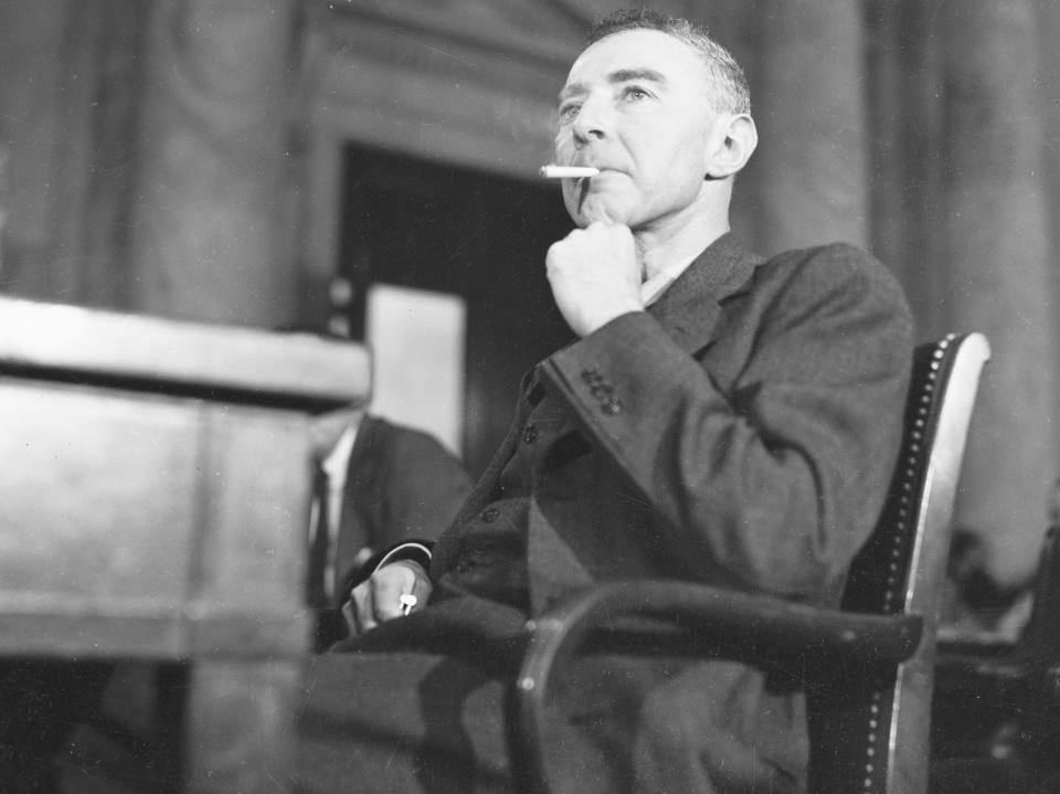 J. Robert Oppenheimer smokes at a hearing in 1949.