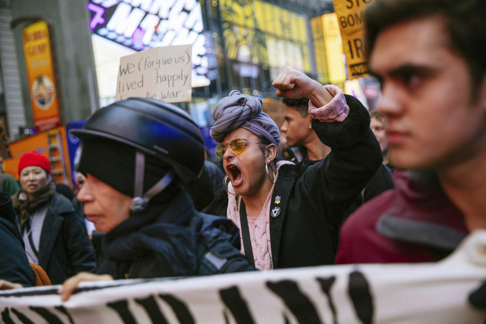 Activists march in Times Square to protest recent U.S. military actions in Iraq on Saturday, Jan. 4, 2020, in New York. A top Iranian general and Iraqi militiamen were killed in a U.S. airstrike that sharply escalated tensions across the region. (AP Photo/Kevin Hagen).