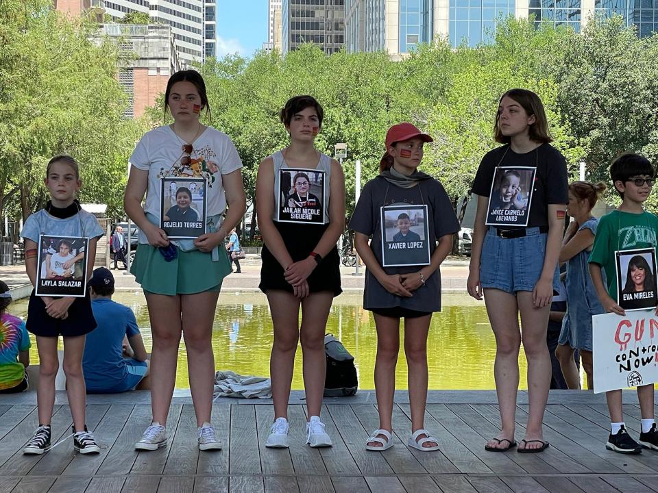 Children wear the names of students killed at in Uvalde, Texas at Robb Elementary school in Houston outside of the NRA convention on May 27, 2022.