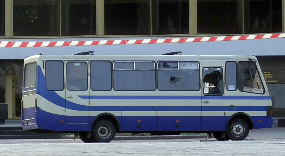 A bus with people hostage after an armed man seized a bus and took some 10 people hostage in the city centre of Lutsk, some 400 kilometers (250 miles) west of Kyiv, Ukraine on Tuesday July 21, 2020. The assailant is armed and carrying explosives, according to a Facebook statement by Ukrainian police. Police officers are trying to get in touch with the man and they have sealed off the area. (Ukrainian Police Press Office via AP)