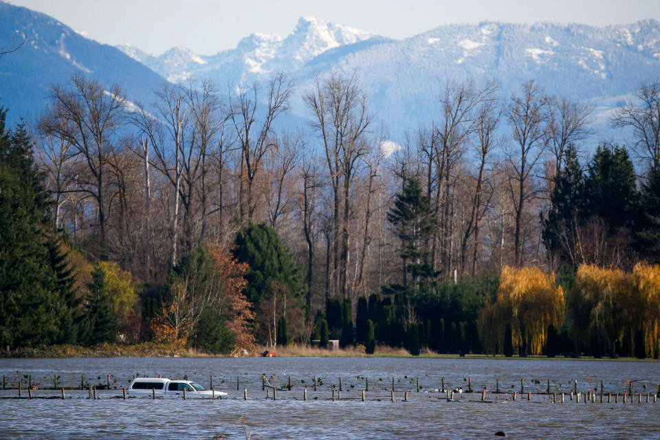 Image: A partially submerged car in floodwaters from the Skagit River that inundated farmland outside of Burlington, Wash., on Nov. 17, 2021. (Joe Nicholson / AFP - Getty Images)