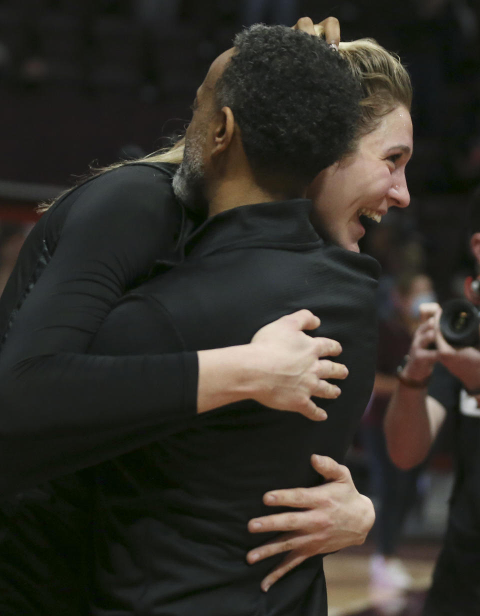 Virginia Tech's Elizabeth Kitley, right, and head coach Kenny Brooks hug after an NCAA college basketball game against North Carolina in Blacksburg, Va., Sunday, Feb. 12, 2022. (Matt Gentry/The Roanoke Times via AP)