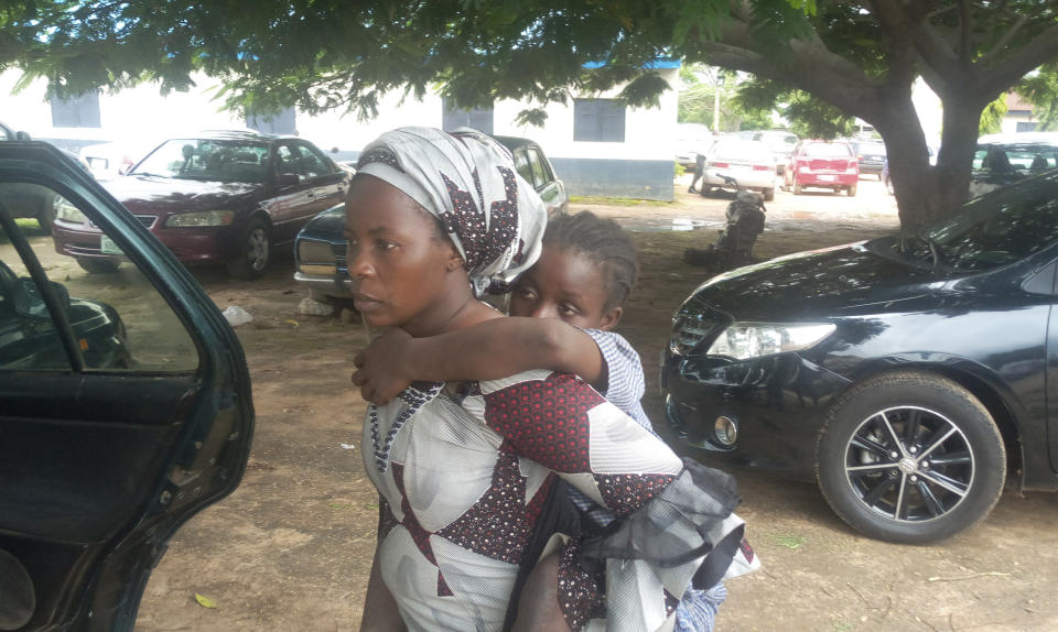 Parents are reunited with released students of the Bethel Baptist High School in Damishi, Nigeria, on Sunday, July 25, 2021. Armed kidnappers in Nigeria have released 28 of the more than 120 students who were abducted at the beginning of July from the Bethel Baptist High School in the northern town of Damishi. Church officials handed those children over to their parents at the school on Sunday. (AP Photo)