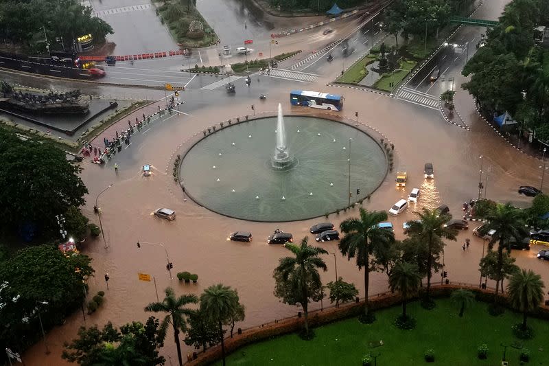 Transportation along a flooded street in Jakarta