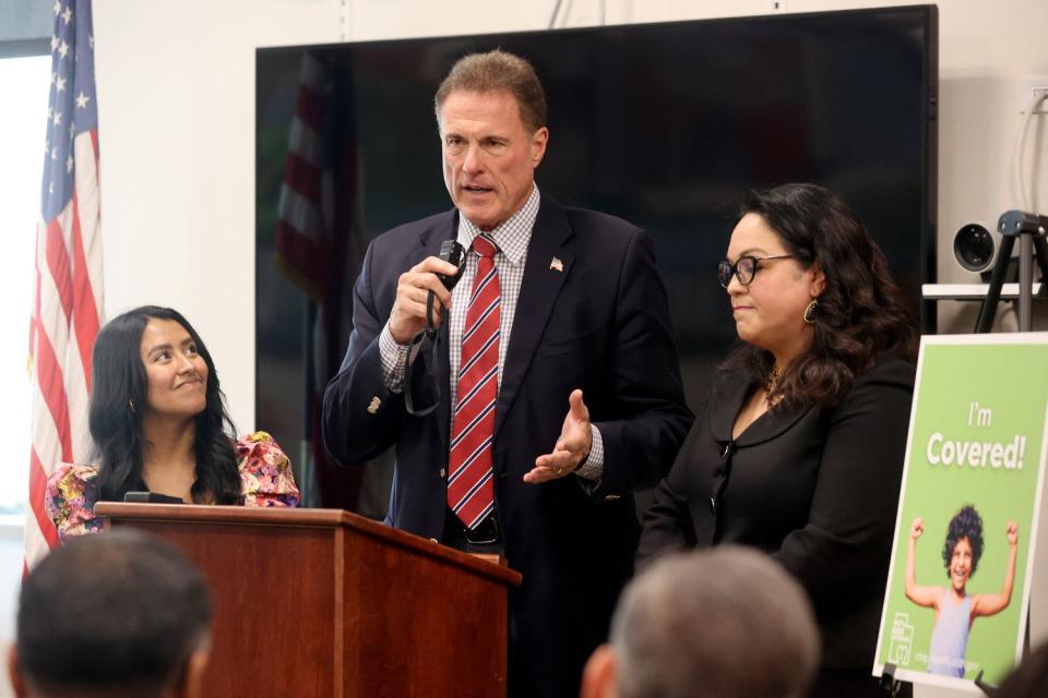 Rep. Jim Dunnigan, R-Taylorsville, speaks during a press conference on a children's health insurance expansion for children of immigrants at the Glendale Community Learning Center in Salt Lake City on Wednesday. Senate Minority Leader Luz Escamilla, D-Salt Lake City, is on the right. Ciriac Alvarez Valle, Voices for Utah Children senior policy analyst and translator, is on the left.