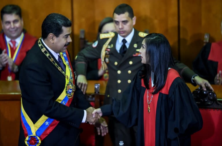 Venezuelan President Nicolas Maduro (L) shakes hands with President of Venezuela's Supreme Court of Justice Gladys Maria Gutierrez, after the ceremony where Maduro delivered a speech reviewing his year in office in Caracas on January 15, 2017