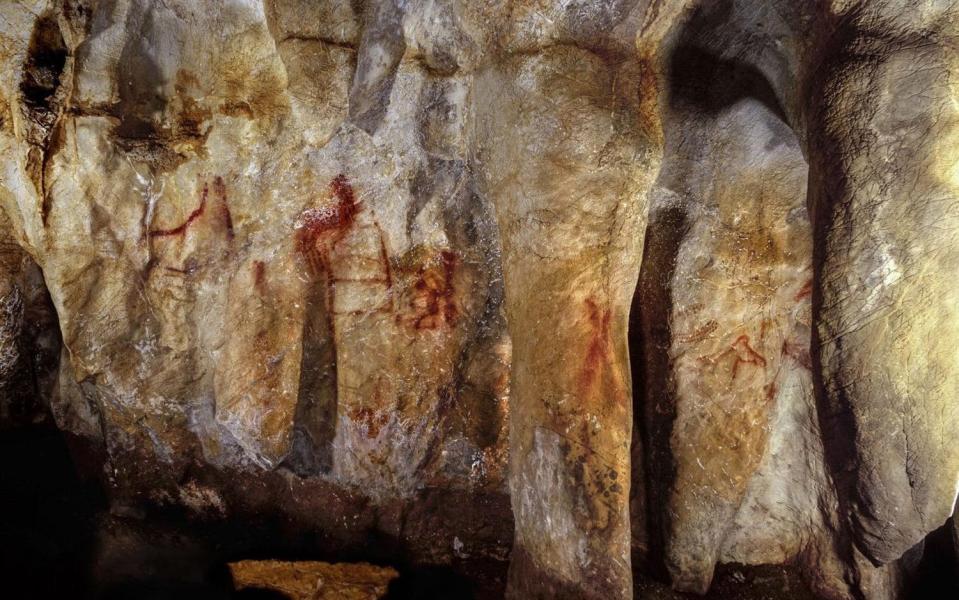 Paintings on a section of La Pasiega cave wall, where the ladder shape composed of red horizontal and vertical lines (centre left) dates to older than 64,000 years - PA