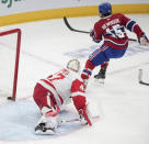 Montreal Canadiens' Alex Newhook (15) scores on Detroit Red Wings goaltender James Reimer (47) during the first period of an NHL hockey game Tuesday, April 16, 2024, in Montreal. (Christinne Muschi/The Canadian Press via AP)