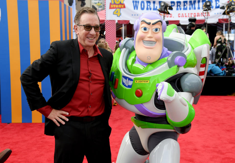 Tim Allen attends the premiere of Toy Story 4 in 2019 with a Buzz Lightyear mascot.