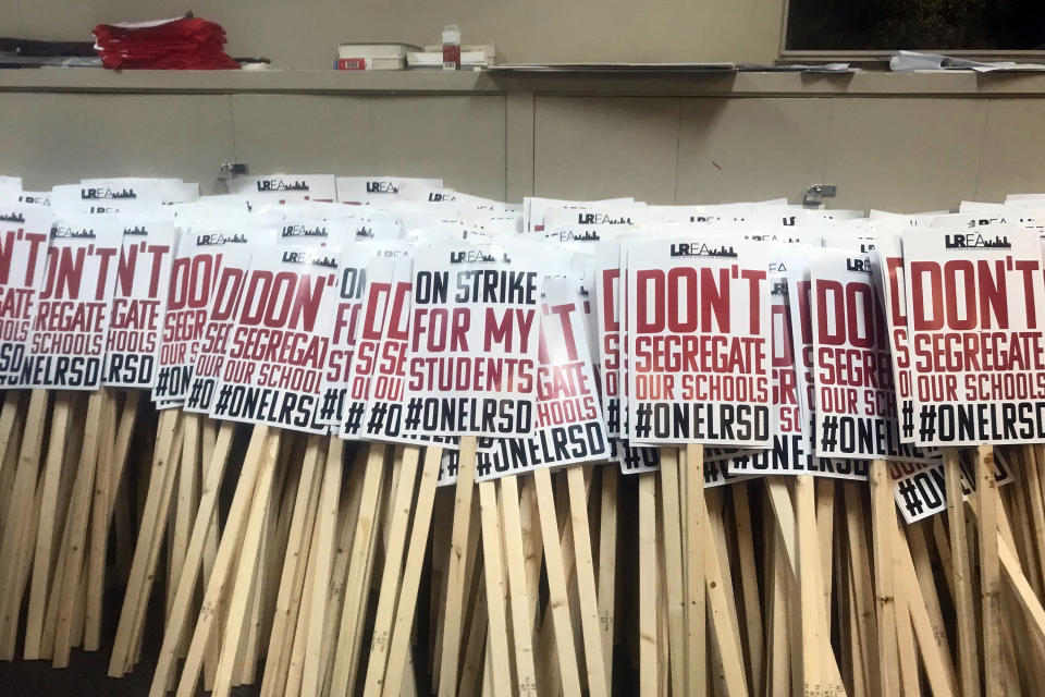 In this on Tuesday, Nov. 12, 2019 photo, signs for striking teachers are lined up at the Arkansas Education Association in Little Rock, Ark. Little Rock teachers plan to hold their first strike in decades on Thursday, Nov. 14, over the state's control of the local school district and a panel's decision to strip their collective bargaining rights. (AP Photo/Andrew Demillo)