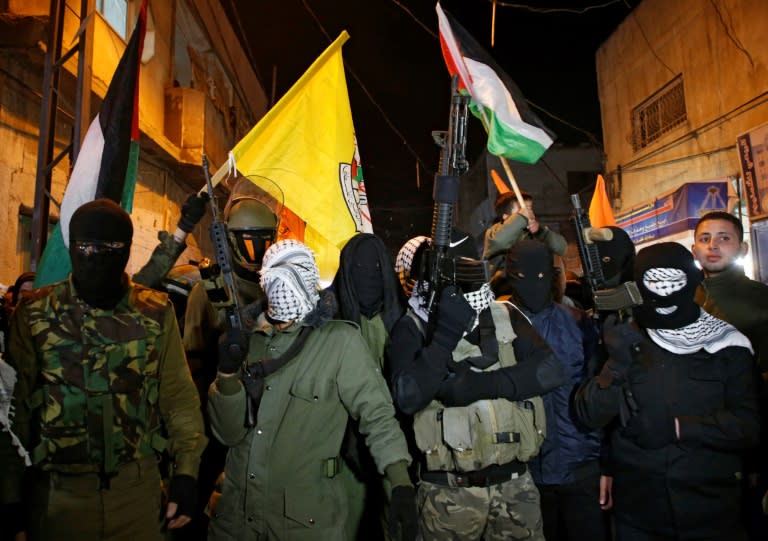 Palestinian militants of Al-Aqsa Martyrs Brigades demonstrate against the US president's recognition of Jerusalem as the capital of Israel at Al-Fawar refugee camp in the occupied West Bank
