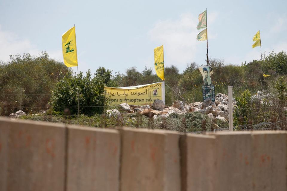 A picture taken on July 3, 2022, shows a pro-Hezbollah placard which reads "Our votes and our rockets are accurate" on the Lebanese side of the border with Israel near the Israeli Kibbutz of Shtula. - The Israeli army said on July 2, that it had intercepted three drones launched by Hezbollah that were headed towards an offshore gas field in the Mediterranean, amid rising tension between Israel and Lebanon. Lebanon's Iran-backed Hezbollah movement in a statement confirmed it had launched drones towards the offshore area. (Photo by JALAA MAREY / AFP) (Photo by JALAA MAREY/AFP via Getty Images)