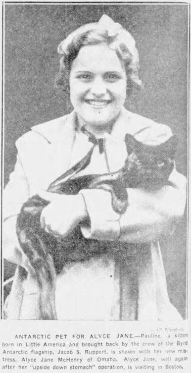 Alyce Jane McHenry holds a cat she received as a gift from scientists, born aboard a Byrd Antarctic expedition vessel, on June 1, 1935.