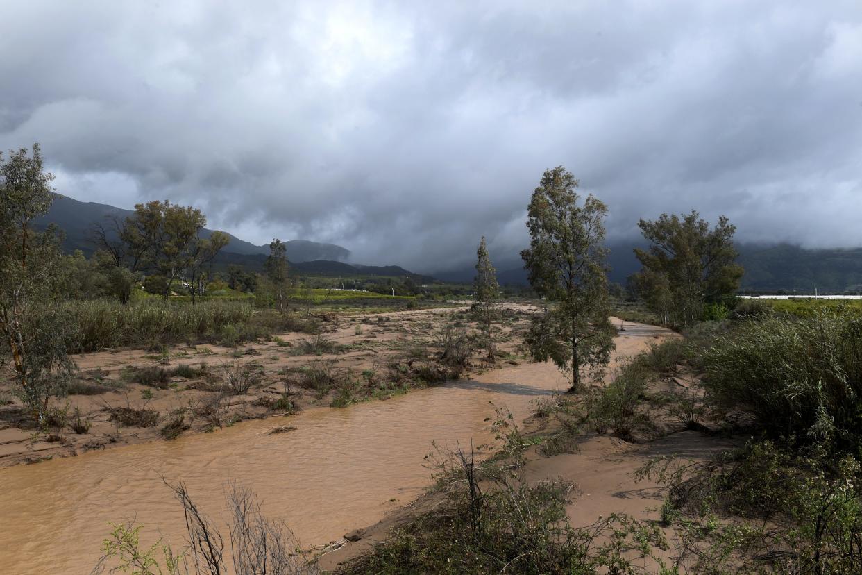 Water flows through the Sespe Creek as dark clouds hover above Fillmore amid intermittent showers on March 21. Rain, thunderstorms and snow were possible overnight Wednesday into Thursday morning.