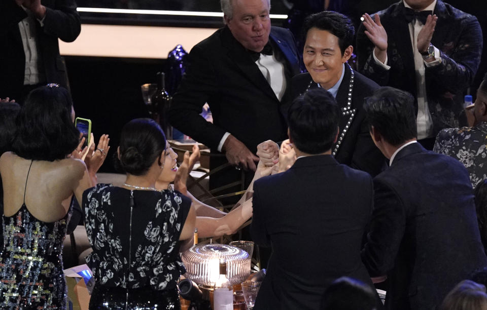 The cast of "Squid Games" congratulates their fellow cast mate, Lee Jung-jae, the winner of the Emmy for outstanding lead actor in a drama series for "Squid Game" at the 74th Primetime Emmy Awards on Monday, Sept. 12, 2022, at the Microsoft Theater in Los Angeles. (AP Photo/Mark Terrill)