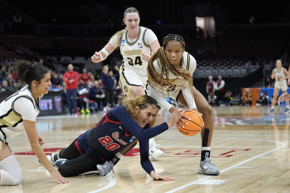 St. John's forward Rayven Peeples (20) tries to defend Purdue guard Jayla Smith (3) in the second half of a First Four women's college basketball game in the NCAA Tournament Thursday, March 16, 2023, in Columbus, Ohio. St. John's won 66-64. (AP Photo/Paul Sancya)