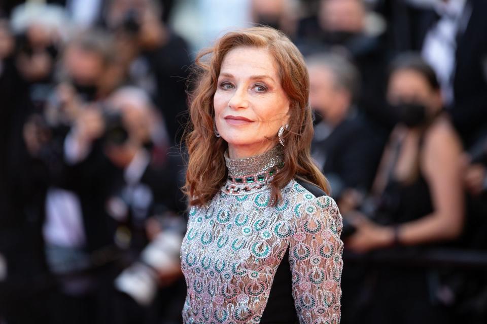 isabelle huppert, in close up, wearing a patterned dress on a red carpet at the cannes film festival