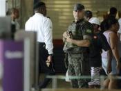 An army officer stands guard in a shopping center during a police strike in Salvador, Bahia state, April 17, 2014. REUTERS/Valter Pontes