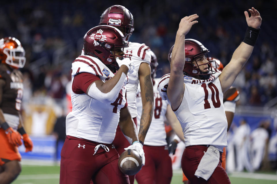 New Mexico State running back Star Thomas, left, and quarterback Diego Pavia (10) celebrate after Thomas' pass reception touchdown against Bowling Green during the first half of the Quick Lane Bowl NCAA college football game, Monday, Dec. 26, 2022, in Detroit. (AP Photo/Al Goldis)