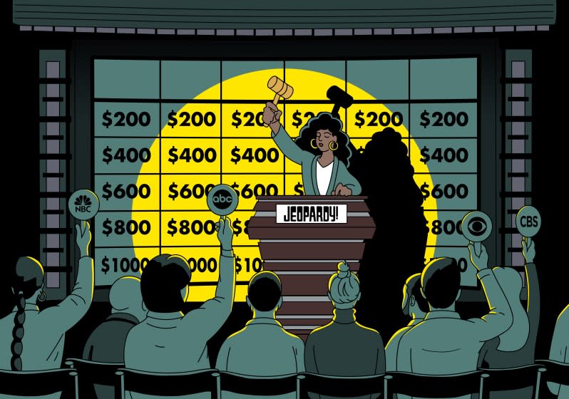 Auctioneer takes bids in front of a "Jeopardy" game board.