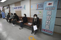Nursing home workers wait to receive the first dose of the AstraZeneca COVID-19 vaccine at a health care center in Seoul Friday, Feb. 26, 2021. South Korea on Friday administered its first available shots of coronavirus vaccines to people at long-term care facilities, launching a mass immunization campaign that health authorities hope will restore some level of normalcy by the end of the year. (Jung Yeon-je /Pool Photo via AP)