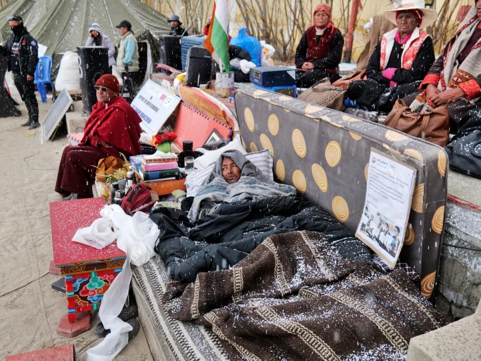 Sonam Wangchuk, lying under blankets, is surrounded by supporters during his hunger strike (AP)