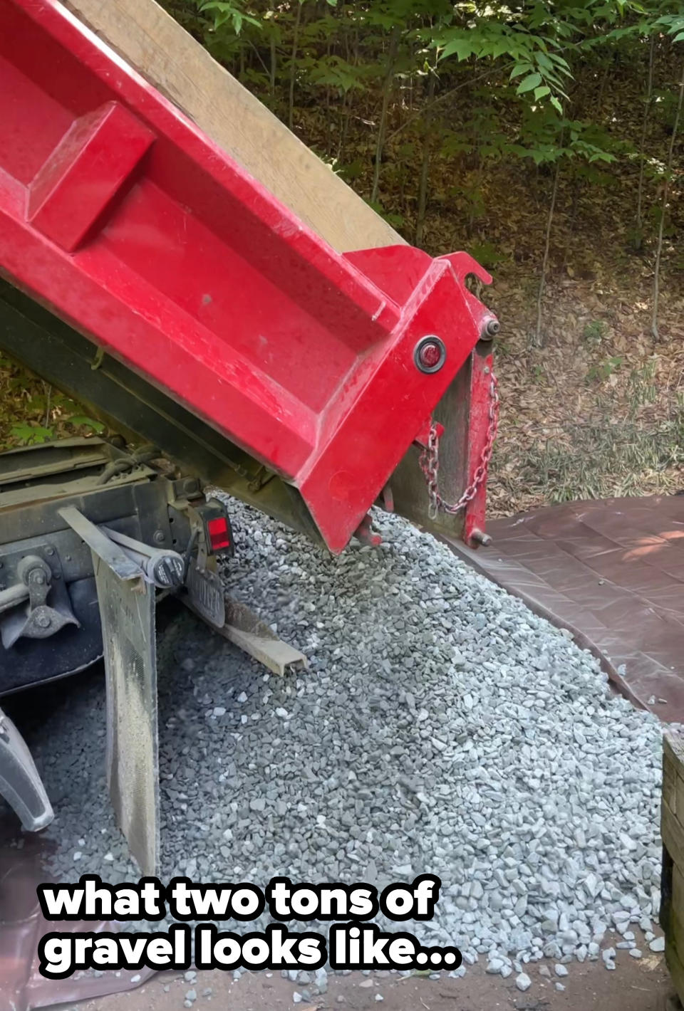 two tons of gravel being dumped onto a tarp