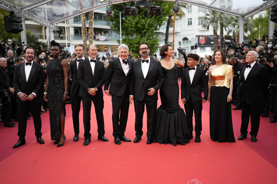 Producer Simon Emanuel, from left, Shaunette Renee Wilson, Boyd Holbrook, Mads Mikkelsen, Harrison Ford, director James Mangold, Phoebe Waller-Bridge, Ethann Isidore, producer Kathleen Kennedy and producer Frank Marshall pose for photographers upon arrival at the premiere of the film 'Indiana Jones and the Dial of Destiny' at the 76th international film festival, Cannes, southern France, Thursday, May 18, 2023. (Photo by Scott Garfitt/Invision/AP)