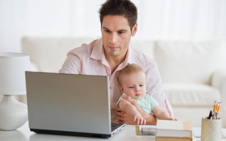 Is that a dad multi-tasking? Never - Alamy