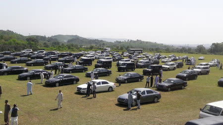 People visit an auction of government owned used cars at the premises of Prime Minister House in Islamabad, Pakistan September 17, 2018. REUTERS/Faisal Mahmood