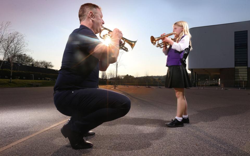 Guzelian Abigail James (9), playing cornet, a member of Bradford Youth Brass Band rehearses with her music teacher, Morgan Griffiths, for the first time in 13 months, at Titus Salt School in Baildon, West Yorkshire - Guzelian/Lorne Campbell 