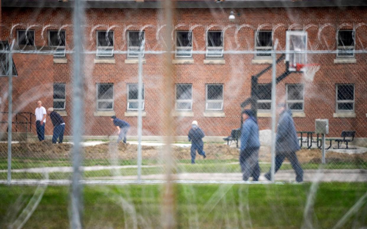 Inmates exercise in the yard at the Marion Correctional Institution  - Reuters