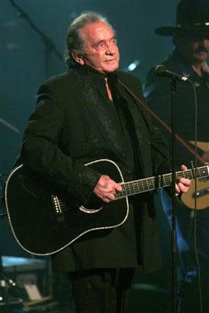 File photograph shows singer Johnny Cash performing a song at the end of a tribute in his honor in New York, April 6, 1999. REUTERS/Files