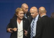 Pauline Marois, leader of the Parti Quebecois, is escorted by the security personnel after a gunman opened fire during her victory speech on September 4 in Montreal. A gunman was arrested after shooting two people, one of them fatally, at the speech