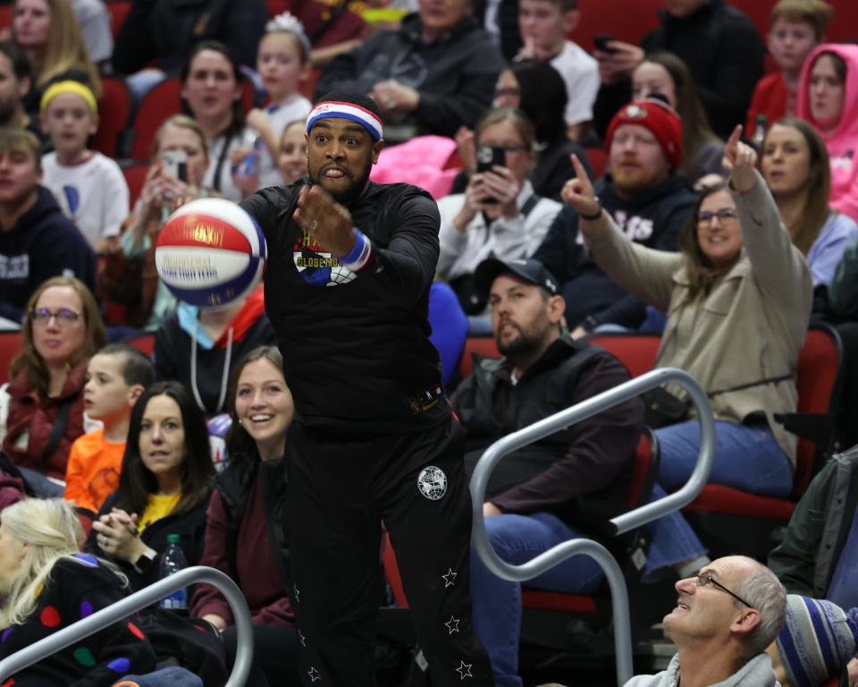 Jan 7, 2024; Des Moines, Iowa, USA; Harlem Globetrotters CHEESE CHISHOLM (11) shoots from the crowd before their game with the Washington Generals at Wells Fargo Arena. Mandatory Credit: Reese Strickland-for the Register