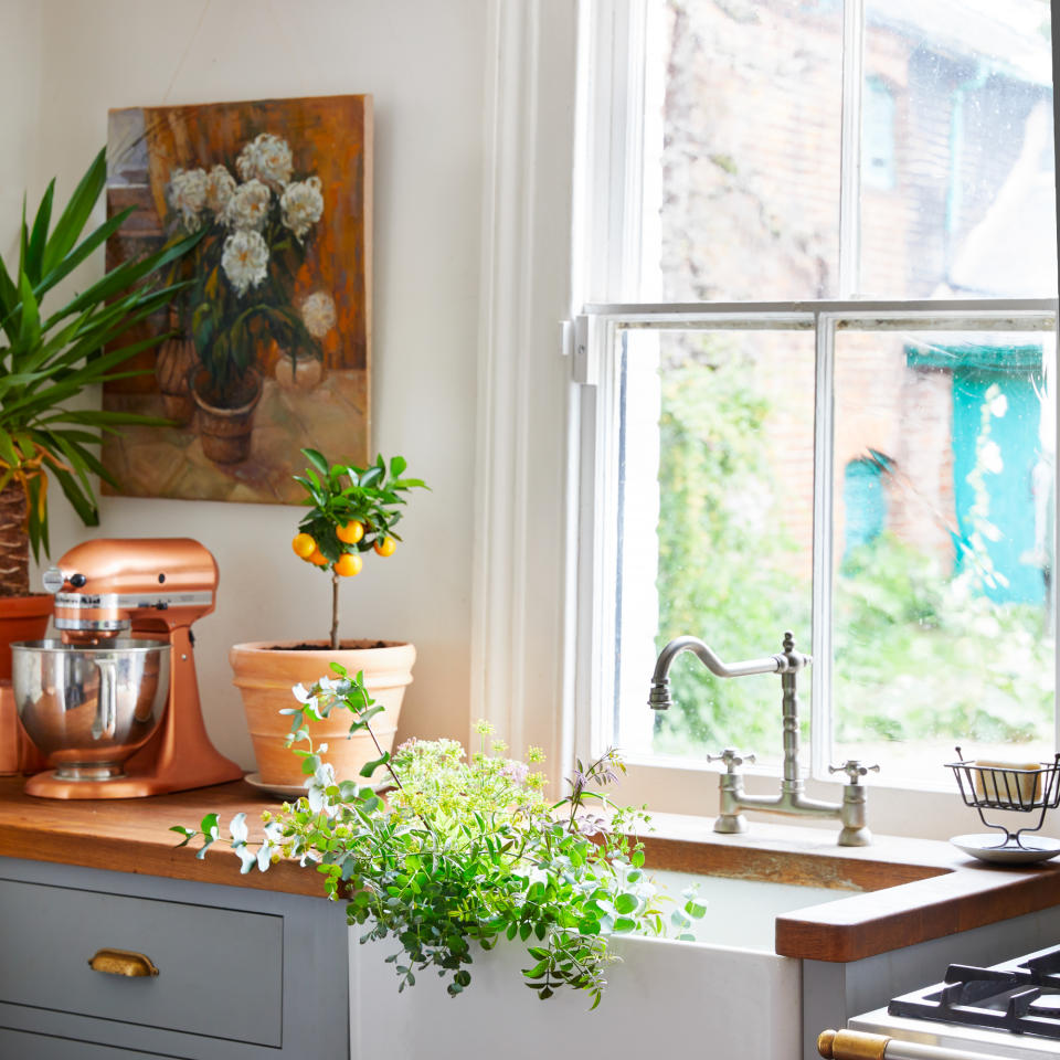 Kitchen with wooden countertops overlooking into large open windows