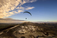 A paraglider flying over Mam Tor, a 517m hill near Castleton in Derbyshire. (Photo by Danny Lawson/PA Images via Getty Images)