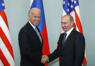 FILE - In this March 10, 2011, file photo, then-Vice President Joe Biden, left, shakes hands with Russian Prime Minister Vladimir Putin in Moscow, Russia. Hit by a barrage of new sanctions from the Biden administration, the Kremlin is carefully weighing its response in a tense showdown with the United States. (AP Photo/Alexander Zemlianichenko, File)