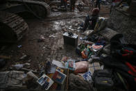 Residents' belongings can been seen in the rubble of collapsed buildings in the coastal city of Izmir, Turkey, Monday, Nov. 2, 2020. In scenes that captured Turkey's emotional roller-coaster after a deadly earthquake, rescue workers dug two girls out alive Monday from the rubble of collapsed apartment buildings three days after the region was jolted by quake that killed scores of people. Close to a thousand people were injured. (AP Photo/Emrah Gurel)