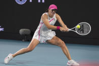 Iga Swiatek, of Poland, returns a shot from Ekaterina Alexandrova, of Russia, during the Miami Open tennis tournament, Monday, March 25, 2024, in Miami Gardens, Fla. (AP Photo/Wilfredo Lee)