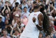 Dustin Brown of Germany celebrates after winning his match against Rafael Nadal of Spain at the Wimbledon Tennis Championships in London, July 2, 2015. REUTERS/Stefan Wermuth