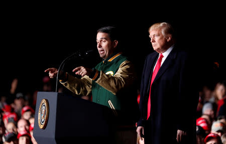 FILE PHOTO: Wisconsin Governor Scott Walker speaks to the crowd as U.S. President Donald Trump looks on at a campaign rally in Mosinee, Wisconsin, U.S., October 24, 2018. REUTERS/Kevin Lamarque/File Photo