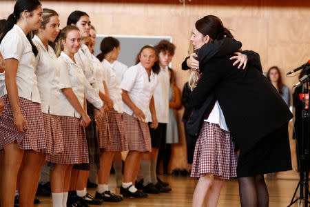 New Zealand's Prime Minister Jacinda Ardern hugs a student during her visit to Cashmere High School in Christchurch, New Zealand March 20, 2019. REUTERS/Edgar Su