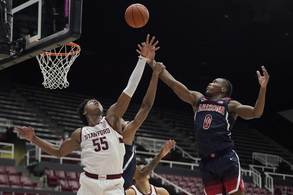 Stanford forward Harrison Ingram (55) jumps for a rebound next to Arizona guard Bennedict Mathurin (0) during the first half of an NCAA college basketball game in Stanford, Calif., Thursday, Jan. 20, 2022. (AP Photo/Jeff Chiu)