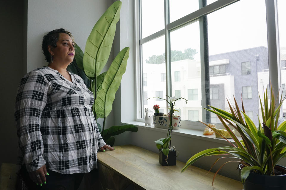 Lisa Raskin, who is a teacher at Jefferson Union High School District, poses for a photograph inside her new one-bedroom apartment in Daly City, Calif., Friday, July 8, 2022. The school district in San Mateo County is among just a handful of places in the country with educator housing. But with a national teacher shortage and rapidly rising rents, the working class district could serve as a harbinger as schools across the U.S. seek to attract and retain educators. (AP Photo/Godofredo A. Vásquez)